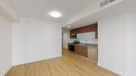 Located at 500 NE First Ave in the heart of downtown Miami, this single-floor unit presents a clean, contemporary design throughout. Light wood-look flooring flows consistently across the open-concept living and dining area, creating a bright and cohesive aesthetic against crisp white walls.

The kitchen is well-appointed with warm wood-grain cabinetry extending floor to ceiling, complemented by granite countertops, a glass tile backsplash, and a full suite of stainless steel appliances including a range, microwave, dishwasher, and side-by-side refrigerator. A practical in-unit laundry closet with a stacked washer and dryer is conveniently positioned nearby.

The bedroom features floor-to-ceiling sliding glass doors that invite natural light and provide urban views, while dual reach-in closets with built-in shelving and hanging rods offer generous storage. The bathroom is finished with marble-style porcelain tile on both the floors and tub surround, a wood-vanity with granite countertop, under-mount sink, and a large mirror. The overall ambiance of the unit is modern, minimal, and well-suited to urban living.