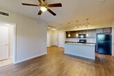 Located at 3852 Telephone Rd in Houston, TX, this single-story 2-bedroom, 2-bathroom home offers a thoughtfully designed open-concept layout. Wood-style flooring flows throughout the main living areas, complemented by neutral wall tones that create a bright, welcoming ambiance. The living room is anchored by a ceiling fan and benefits from natural light through large windows, while track lighting adds functional illumination throughout.

The kitchen is a standout feature, equipped with dark espresso cabinetry, granite countertops, a subway tile backsplash, black appliances including a gas range, and a peninsula with pendant lighting and an integrated sink — ideal for both cooking and casual dining. A dedicated dining area and pantry provide additional convenience.

The primary bedroom is a comfortable retreat with its own ceiling fan and an en-suite bathroom featuring granite countertops, dark cabinetry, and a glass-enclosed shower. The second bathroom offers a full soaking tub with tiled surround and tile flooring. Both bedrooms include access to closets, with the primary suite featuring a spacious walk-in closet with wire shelving. Additional highlights include an in-unit laundry area and ample storage throughout.