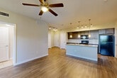 Located at 3852 Telephone Rd in Houston, TX, this single-story 2-bedroom, 2-bathroom home offers a thoughtfully designed open-concept layout. Wood-style flooring flows throughout the main living areas, complemented by neutral wall tones that create a bright, welcoming ambiance. The living room is anchored by a ceiling fan and benefits from natural light through large windows, while track lighting adds functional illumination throughout.

The kitchen is a standout feature, equipped with dark espresso cabinetry, granite countertops, a subway tile backsplash, black appliances including a gas range, and a peninsula with pendant lighting and an integrated sink — ideal for both cooking and casual dining. A dedicated dining area and pantry provide additional convenience.

The primary bedroom is a comfortable retreat with its own ceiling fan and an en-suite bathroom featuring granite countertops, dark cabinetry, and a glass-enclosed shower. The second bathroom offers a full soaking tub with tiled surround and tile flooring. Both bedrooms include access to closets, with the primary suite featuring a spacious walk-in closet with wire shelving. Additional highlights include an in-unit laundry area and ample storage throughout.
