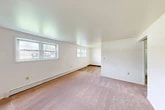 Located at 416 Clubhouse Rd in Vestal, NY, this two-bedroom, one-bathroom residence offers a practical and well-organized single-floor layout. The space features a mix of warm hardwood flooring in the main living and kitchen areas, transitioning to plush carpeting in both bedrooms, creating a comfortable and cohesive feel throughout.

The spacious primary bedroom is generously sized, featuring multiple windows that bring in natural light, baseboard heating, and a built-in closet with classic paneled double doors. The second bedroom is equally well-lit, with its own window and baseboard heater. Both rooms are finished with clean white walls, providing a bright, neutral backdrop.

The bathroom is neatly appointed with white subway tile wainscoting accented by a light blue tile border, a vanity with under-cabinet storage, a mirror cabinet, and hardwood flooring — offering a clean, functional design.

The kitchen area includes white cabinetry and appliances, opening toward the living space for an easy flow. An entrance foyer, hallway, and dedicated closet round out the layout, adding practical storage and transition space. Baseboard heating is present throughout, ensuring year-round comfort. Overall, the residence presents a clean, move-in-ready environment with a straightforward, functional design.