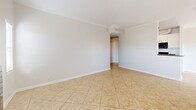 Located at 18540 Citronia St in Los Angeles, CA, this 2-bedroom, 4-bathroom residence offers a well-designed single-floor layout with a comfortable and functional living environment. The open-concept living and dining area is finished with light ceramic tile flooring, crown molding, and a ceiling fan, creating a bright and airy atmosphere. A striking black-tiled fireplace serves as a focal point, flanked by windows that invite natural light and outdoor views. The galley-style kitchen is equipped with white cabinetry, dark granite countertops, a double stainless steel sink, and black appliances including a gas range, refrigerator, and dishwasher — offering both style and practicality. The two bedrooms feature plush carpeting and mirrored sliding closet doors, with the primary bedroom providing a generous layout and ample natural light through horizontal blinds. Five closets throughout the unit ensure abundant storage. The four bathrooms are finished with tile flooring and clean, bright fixtures, including a tub-shower combination. A private balcony accessible from the living area provides an outdoor retreat. Hallways connect the spaces efficiently, completing a well-organized and comfortable floor plan.