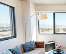 This contemporary 2-bedroom apartment in San Francisco offers a harmonious blend of style and functionality. The open-plan living area features large windows that flood the space with natural light and provide breathtaking bay views. The kitchen boasts modern appliances, light wood cabinetry, and a clean white backsplash, creating an inviting culinary space.

The bedrooms are well-appointed, with one room featuring a cozy bunk bed perfect for children or guests. The primary bedroom offers a serene retreat with ample natural light and city views. The bathroom is sleek and minimalist, with a floating vanity and modern fixtures.

Throughout the apartment, hardwood floors add warmth and continuity. The living room is tastefully furnished with a mid-century modern aesthetic, including a plush sofa, unique coffee table, and stylish sideboard. Carefully curated art pieces and plants add personality and life to the space.

Storage solutions are integrated seamlessly, with built-in closets and dressers providing ample room for personal belongings. The apartment's design maximizes space efficiency while maintaining an open, airy feel. With its prime location and thoughtful design, this apartment offers a perfect urban oasis in the heart of San Francisco.