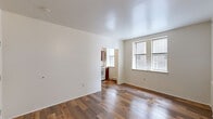 Located at 1623 W Chelten Ave in Philadelphia, PA, this one-bedroom, one-bathroom unit offers a practical and well-organized single-floor layout. Rich hardwood flooring runs throughout the entire space, lending warmth and consistency to each room.

The living room is bright and open, featuring multiple windows that invite generous natural light and a clean, neutral color palette with crisp white walls and ceilings. An open passageway connects the living area to the kitchen, which is equipped with warm reddish-brown upper and lower cabinetry, a gas range, a refrigerator, a stainless steel sink, and a window above the counter for added light and ventilation.

The bedroom is a comfortable, well-proportioned room with a large window fitted with blinds, offering ample natural light. The room features multiple closet doors, providing solid built-in storage options. A hallway connects the key areas of the unit, with an open shelved closet adding additional storage.

The bathroom includes a full tub and shower combination with classic subway tile surrounds and a window for natural light and ventilation. Throughout the unit, the hardwood flooring, neutral walls, and functional layout come together to create a clean and efficient living space.