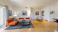 Located at 909 W Temple St in Los Angeles, this two-bedroom, two-bathroom residence offers a thoughtfully designed single-level floor plan. The open-concept living and dining area is anchored by warm hardwood flooring, crown molding, and neutral tones that create a bright, welcoming ambiance. A sliding glass door leads to a private balcony overlooking lush greenery, filling the space with natural light. The galley-style kitchen features rich wood cabinetry, dark granite countertops, stainless steel appliances, and tile flooring, complemented by a breakfast bar with seating — ideal for casual dining. Both bedrooms offer hardwood floors, generous natural light from large windows with outdoor views, and dedicated closet space. The primary bedroom provides a comfortable retreat with room for a full furniture arrangement. Each bathroom is finished with wood vanities, granite countertops, tile flooring, and a shower-tub combination. A dual-sink vanity in the primary bath adds practicality. Two closets throughout the unit offer ample storage. The overall design balances modern finishes with functional layout, making this a well-appointed residence in the heart of Los Angeles.