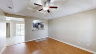 Located at 121 E Quamasia Ave in McAllen, Texas, this single-story, one-bedroom, one-bathroom home offers a well-designed layout that maximizes functionality and comfort. The open-concept living area greets you at the entry with warm hardwood-style flooring, a distinctive tray ceiling, and a ceiling fan that adds both style and practicality. Natural light flows in through windows fitted with blinds, creating a bright and welcoming atmosphere. An arched passageway connects the living area to the kitchen, which is well-appointed with rich dark espresso cabinetry, granite-look countertops, a mosaic tile backsplash, and white appliances including a refrigerator, range, microwave, and dishwasher. Light ceramic tile flooring and a sliding glass door to the outside further enhance the kitchen's appeal. The spacious bedroom features plush carpeting, a tray ceiling with ceiling fan, and a window with natural views. A dedicated closet provides ample storage. The bathroom offers a full shower-tub combo, dark wood cabinetry for storage, and tile flooring. A hallway connects the rooms cohesively, completing this efficiently designed and move-in-ready home.