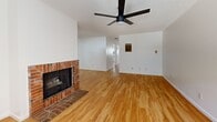 Located in Glendale, CA, this single-story 2-bedroom, 1-bathroom home offers a well-designed layout with consistent light hardwood flooring throughout. The living room serves as the focal point of the home, featuring a classic brick fireplace, a ceiling fan, a wall-mounted AC unit, and a window that allows natural light to fill the space. The adjacent kitchen is thoughtfully updated with white cabinetry, granite-style countertops, a mosaic tile backsplash, stainless steel appliances including a gas range and over-the-range microwave, and a window above the sink that brings in additional natural light. The dining area connects seamlessly to the living and kitchen spaces, supporting an open, functional flow. Both bedrooms are bright and well-proportioned, each equipped with ceiling fans and textured ceilings. The primary bedroom offers a comfortable footprint with ample room for furnishings. One bedroom includes a sliding-door closet for convenient storage, and dedicated closet spaces are available throughout. The bathroom features a wood-framed vanity mirror, single-sink vanity with stone-style countertop, toilet, and a standalone glass-door shower. The clean, neutral palette and consistent finishes create a cohesive and move-in-ready living environment.