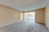 Located at 3603 W Hillsdale Ave in Visalia, California, this single-story, 2-bedroom, 1-bathroom residence offers a practical and comfortable layout across a compact yet efficiently organized floor plan. The entrance leads into a hallway that connects all major rooms seamlessly.

The living room is a bright, open space with plush wall-to-wall carpeting, warm beige walls, and a textured ceiling. A large sliding glass door fitted with vertical blinds allows abundant natural light to pour in while providing outdoor views and patio access.

The galley-style kitchen is well-equipped, featuring dark-toned wood cabinetry on both sides, neutral laminate countertops, a white electric range, refrigerator, and a double sink. Stone-patterned tile flooring adds durability and visual interest throughout the kitchen and extends into the bathroom.

Both bedrooms are generously proportioned, carpeted, and painted in soft, neutral tones. The primary bedroom benefits from built-in closets, a ceiling fan with light fixture, and a window that brings in natural light. The second bedroom also features carpet and a ceiling fan.

The bathroom is clean and functional, offering a vanity with storage, a toilet, and a full bathtub with a sliding frosted-glass shower enclosure. A hallway connects the bedrooms to the shared bathroom, completing this well-organized and comfortable home.