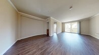 Located at 3250 Market St in Riverside, CA, this well-appointed 2-bedroom, 2-bathroom residence offers a thoughtfully designed single-level layout. The open living and dining area immediately impresses with rich dark hardwood-style flooring, elegant crown molding, and recessed lighting. Large sliding glass doors lead to a private balcony framed by decorative arched windows, allowing abundant natural light to fill the space and providing pleasant outdoor views.

The kitchen is efficiently designed with warm wood cabinetry, granite-style countertops, tile flooring, and a full suite of stainless steel appliances including a gas range, built-in microwave, and refrigerator. A hallway connects the main living area to the private quarters of the home.

The spacious primary bedroom features hardwood-style flooring, crown molding, and its own sliding glass door opening to the balcony, creating a bright and airy retreat. A dedicated walk-in closet with wire shelving provides generous storage. The second bedroom is carpeted and bathed in natural light through a set of large windows overlooking lush greenery. Both bathrooms are well-appointed, with one featuring a soaking tub, tile flooring, built-in shelving, and a wood-vanity with stone countertops. The overall ambiance is clean, neutral, and move-in ready.