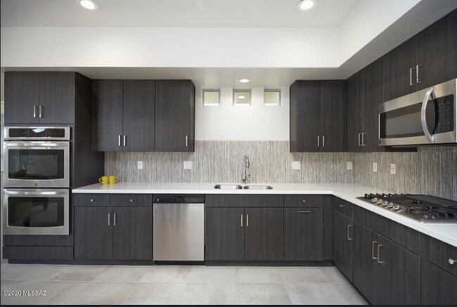 Model picture - Rental house kitchen has black cabinets and no backsplash - 8682 E Avant Garde Way