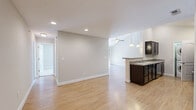 Located at 1061 Spring Creek Dr in Forest, VA, this well-appointed 2-bedroom, 2-bathroom single-floor home offers a comfortable and functional layout. The open-concept living and dining area is a standout feature, boasting vaulted ceilings, a ceiling fan, and light hardwood-style flooring that flows throughout the main living spaces. A fireplace anchors the living room, which is bathed in natural light through a sliding glass door that opens to a private deck overlooking lush, wooded surroundings. The kitchen features dark espresso cabinetry, granite-style countertops, black appliances, and a convenient peninsula with a sink. A stacked washer and dryer unit is tucked neatly within the kitchen area for added convenience. Both bedrooms are carpeted and include ceiling fans; the secondary bedroom offers a bright window with blinds, while the generously sized primary bedroom provides ample space. The home includes two full bathrooms: one with a walk-in shower and dark vanity cabinetry, and another with a tub/shower combination. Additional storage is provided by five closets throughout the home, along with a utility room and dedicated hallway. Recessed lighting and neutral tones give the entire space a clean, move-in-ready feel.