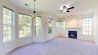 Located at 247 Marcliffe Dr in Valparaiso, Indiana, this home offers a well-organized layout with a variety of comfortable living spaces. The spacious living room serves as the heart of the home, featuring a classic fireplace with a white mantel, plush carpeting, a ceiling fan, track lighting, and an abundance of natural light streaming through multiple large windows that frame views of surrounding greenery. The kitchen is thoughtfully designed with white cabinetry, a tile mosaic backsplash, a double-basin sink, a gas range, dishwasher, and full-size refrigerator. Warm hardwood flooring adds character to the kitchen area, while a French door provides direct access to the outdoor space. The bedrooms are carpeted and well-lit, with generously sized windows offering views of the neighborhood and surrounding trees. The carpeted staircase, equipped with a white handrail, connects the levels of the home with a clean, functional design. Throughout the home, neutral wall tones and consistent finishes create a cohesive and inviting atmosphere, making this Valparaiso property a comfortable and practical living space.