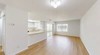 Located at 4616 SW 8th Pl in Cape Coral, Florida, this 2-bedroom, 2-bathroom residence offers a bright and functional single-floor layout. Light wood flooring runs throughout the unit, creating a clean, cohesive aesthetic. The open-concept living and dining area is filled with natural light from large windows and sliding glass doors that lead to a private balcony, offering pleasant outdoor views of the surrounding Florida landscape.

The kitchen features white cabinetry, light countertops, a double stainless steel sink, an electric range, and a skylight that brings in additional natural light. A pass-through counter connects the kitchen to the living area, enhancing the open feel. A dedicated pantry and laundry area add to the unit's practicality.

Both bedrooms are well-sized, featuring light wood floors, natural light from windows with blinds, and louvered bifold closet doors providing generous storage. The primary bedroom includes its own en-suite bathroom with a vanity and windowed natural light. The second bathroom offers a full tub-shower combination. Throughout the space, a neutral white and beige color palette creates a clean, airy ambiance well-suited to the sunny Southwest Florida climate. Additional storage is provided across five closets.