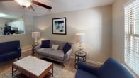 Located at 1272 Union Rd. in Gastonia, NC, this single-story home offers a well-designed layout that balances comfort and functionality throughout. The living area provides a welcoming atmosphere, featuring neutral-toned walls, plush carpeting, and a ceiling fan that adds a relaxed, airy feel. Framed artwork and ample ambient lighting contribute to the space's warm and inviting character.

The kitchen is outfitted with white cabinetry, light countertops, and stainless steel appliances including an electric range and refrigerator. A mosaic tile backsplash in warm earth tones adds a stylish accent, while the double-basin sink and generous counter space support practical everyday use.

The bedrooms are comfortably sized with soft carpet flooring, neutral walls, and natural light from windows with blinds. One bedroom includes a dedicated closet, while both offer a calm and restful setting. The bathrooms are clean and functional, each featuring wood-look tile flooring, a tub-shower combination, vanity with a framed mirror, and light countertops. The overall aesthetic throughout the home is cohesive, with a neutral palette and modern touches that create a move-in-ready environment well-suited for comfortable daily living.