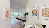 Located at 8200 NW 52nd Terrace in Doral, FL, this well-appointed one-bedroom, one-bathroom residence offers a thoughtfully designed open-concept layout finished with light wood-style flooring and crisp white walls throughout. The galley-style kitchen is equipped with stainless steel appliances, including a range, microwave, refrigerator, and dishwasher, and features granite countertops paired with sleek white cabinetry. A breakfast bar with seating connects the kitchen to the living and dining areas, creating a seamless flow ideal for entertaining. In-unit laundry is conveniently tucked just off the kitchen. The living room is bright and airy, with tall ceilings, sheer curtains, and a glass door that invites natural light and provides access to the outdoors. The bedroom offers a comfortable and tranquil retreat with multiple windows, generous natural light, and a dedicated closet. The bathroom is clean and modern, featuring a granite-topped vanity, a tub-shower combination with tile surround, and matte black fixtures that add a contemporary touch. Throughout the residence, the design strikes a balance between modern minimalism and inviting warmth, creating a cohesive and functional living environment.