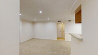 Located at 7277 NE Dunwoody Rd in Atlanta, GA, this one-bedroom, two-bathroom residence presents a thoughtfully arranged single-floor layout designed for comfortable everyday living. The living room is bright and welcoming, featuring recessed lighting, plush neutral carpeting, crown molding, and a large window that invites natural light and outdoor views. The warm, cream-toned walls carry throughout the home, creating a cohesive and calm atmosphere. The kitchen is efficiently laid out with wood-trimmed cabinetry, light stone-finish countertops, stainless steel appliances, and tile flooring that adds a durable, practical touch. The bedroom is a comfortable retreat, carpeted and accented with crown molding and a ceiling fan with light fixture, along with a window providing natural light. A dedicated walk-in closet off the bedroom features built-in wire shelving on multiple walls, offering generous organizational storage. Both bathrooms are finished with tile flooring and include full tub-shower combinations with white subway tile surrounds. A connecting hallway links the rooms seamlessly, completing this functional and neatly presented home in the Sandy Springs area of Atlanta.