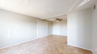 Located at 6575 W Ocotillo Rd in Glendale, Arizona, this two-bedroom, two-bathroom two-story home offers a practical and well-designed layout spread across two floors. The main level features a bright living area with large windows that invite natural light, neutral-toned walls, and light tile flooring. A ceiling fan keeps the space comfortable, while a sliding vertical blind provides easy access to an adjacent area. The kitchen is well-appointed with white cabinetry, stainless steel appliances including an electric range and dishwasher, and ample counter space — all finished with the same tile flooring for a cohesive look. Two bathrooms serve the home, one featuring a full tub-shower combo and tile flooring, and the other with a single vanity, mirror, and tile flooring. Upstairs, both bedrooms are finished with wood-look luxury vinyl plank flooring and textured ceilings. The primary bedroom includes a closet and direct access to a bathroom. The second bedroom features a large window with natural light and ample floor space. A staircase connects both levels, completing this straightforward and functional two-story layout.