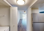 Located at 300 NW 111 Pl in Sweetwater, Florida, this single-floor residence offers a clean, functional layout designed for comfortable everyday living. Throughout the home, rich hardwood-style flooring provides a warm and cohesive aesthetic, complemented by bright white walls and textured ceilings that add subtle character to each room.

The living area is a welcoming, open space anchored by a ceiling fan with light fixture, ensuring year-round comfort. Natural light flows in through a sliding glass door, offering a pleasant view of the outdoors. Adjacent to the living area, a hallway connects the rooms seamlessly, with a louvered-door closet providing in-unit laundry or storage access.

The kitchen is well-appointed with cream cabinetry, white tile backsplash, light countertops, a stainless steel refrigerator, and a stainless steel electric range with an overhead ventilation hood. The layout is efficient and practical for everyday meal preparation.

The bedrooms are generously sized, each featuring hardwood-style flooring, textured ceilings, and windows with vertical blinds that allow for natural light and privacy. Louvered closet doors offer ample storage in each room.

Two full bathrooms complete the home, each featuring a tub-shower combination with chrome fixtures, a window for natural ventilation, and a clean, bright finish throughout.