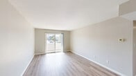 This well-appointed 2-bedroom, 2-bathroom unit in Fort Wayne, Indiana offers a practical and comfortable single-floor layout. The combined living and dining area is bright and open, featuring light wood-style flooring, neutral walls, and a sliding glass door that leads to a private balcony with views of the surrounding community. The kitchen is thoughtfully updated with gray shaker-style cabinetry, dark stone-finish countertops, a white subway tile backsplash, a stainless steel sink, and a dishwasher — all finished with light wood flooring that ties the space together. Both bedrooms feature plush carpet flooring and generous closet space with louvered bifold doors, while one bedroom benefits from a large window that allows ample natural light. The two bathrooms are clean and functional; the primary bathroom includes a double-sink vanity with dark countertops, louvered cabinet doors, and a tiled soaking tub/shower combination. Throughout the unit, five closets provide exceptional storage. A hallway connects the living spaces efficiently, and the private balcony offers an outdoor retreat. The unit's neutral color palette and updated finishes create a cohesive, move-in-ready atmosphere.