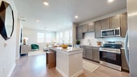 This thoughtfully designed 1-bedroom, 1-bathroom residence offers a comfortable and functional layout across a single floor. Light wood-style flooring flows throughout the unit, creating a warm and cohesive aesthetic. A welcoming entry hallway leads to the heart of the home, where an open-concept kitchen and living area provide an effortlessly connected space for everyday living.

The kitchen is a standout feature, equipped with rich dark-toned cabinetry, stainless steel appliances — including a refrigerator, range, microwave, and dishwasher — and a classic white subway tile backsplash. A central island with a granite-style countertop offers additional prep space and casual seating. The adjoining living area is bright and airy, benefiting from multiple windows that invite natural light and provide outdoor views, complemented by a ceiling fan overhead.

The bedroom is a serene retreat, featuring large windows, a ceiling fan, and access to a dedicated walk-in closet outfitted with wire shelving for organized storage. The full bathroom includes a tub-shower combination with white tile surround, a granite-topped vanity with dark cabinetry, and direct access to the closet. Recessed lighting and neutral tones throughout give the space a clean, modern feel.