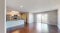 Located at 606 Washington St in the vibrant Mission Hills neighborhood of San Diego, this single-floor residence offers a thoughtfully designed open-concept layout. Rich hardwood flooring flows consistently throughout the space, creating a warm and cohesive aesthetic.

The kitchen is well-appointed with white shaker cabinetry, stainless steel appliances including a refrigerator, range, and over-the-range microwave, complemented by a classic subway tile backsplash and dark countertops. A peninsula with an integrated sink provides additional prep space and opens directly into the generous living area, making it ideal for everyday living and entertaining.

The living area is bright and spacious, benefiting from natural light that pours in through large sliding glass doors, which lead to a private balcony offering views of the surrounding urban landscape. The neutral wall tones throughout the unit create a clean, versatile backdrop.

The bedroom is comfortably sized, featuring a window with shutters that allow for adjustable natural light, and is accompanied by mirrored sliding closet doors that enhance the sense of space. The bathroom is finished with white cabinetry, dark countertops, and a framed mirror, maintaining the consistent modern aesthetic found throughout the home. Additional storage is accessible via a walk-in closet area visible off the main living space.