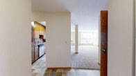 This well-appointed 3-bedroom, 2-bathroom unit with a den is located in St. Louis Park, MN, offering a generous single-floor layout. The expansive living area features plush carpeting, large windows that invite abundant natural light, and a ceiling fan, creating a bright and comfortable atmosphere. A den area includes a standout built-in wooden shelving and cabinetry unit, adding both functional storage and a warm, classic character to the space.

The galley-style kitchen is efficiently designed with rich oak cabinetry, tile flooring, and ample counter space on both sides, accommodating a full suite of appliances including a range, refrigerator, and dishwasher. A double sink completes the practical layout.

The primary bedroom is generously sized and features a ceiling fan and dual bi-fold closet doors, providing excellent storage. Additional bedrooms are carpeted and offer their own closet access, including a room with multiple wood-paneled closet doors. The den provides a flexible space suitable for a home office or guest room.

Both bathrooms are finished with classic white tile, with one featuring a full tub-shower combination and tile surround, and the other with tile wainscoting and stone-look floor tile. Warm oak wood trim and doors are consistent throughout, lending a cohesive, traditional aesthetic to the entire residence.