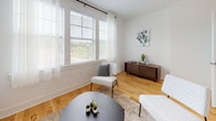 Located at 200 Hopmeadow in Weatogue, Connecticut, this multi-floor residence offers a refined blend of modern design and practical comfort across three levels. The main living area features warm hardwood flooring and an abundance of natural light streaming through large windows dressed with sheer white curtains and classic blinds. The living room provides a welcoming, open atmosphere ideal for both relaxing and entertaining.

The kitchen is well-equipped with dark cabinetry, white quartz countertops, stainless steel appliances, and a subway tile backsplash. A peninsula with an integrated sink adds both function and a clean aesthetic, while the hardwood floors carry a cohesive look throughout the main level.

The bedrooms are carpeted for comfort and feature generous window arrangements, including a charming bay window in one room that floods the space with light. A standout feature is the spacious primary bedroom, which accommodates a striking black four-poster canopy bed frame and benefits from multiple windows with outdoor views of the surrounding neighborhood.

The bathrooms are finished with tile flooring, dark wood vanities, white quartz countertops, and tub-shower combinations with glass sliding doors. A convenient powder room with a pedestal sink and hardwood flooring serves as an additional half bath. Together, these spaces create a cohesive, contemporary living environment.