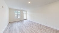 Located at 13300 Ardmore Valley Way in Knoxville, TN, this well-designed two-bedroom, two-bathroom single-floor home offers a clean, modern aesthetic with thoughtful finishes throughout. The open-concept living room greets you with light wood-style flooring, recessed lighting, and large windows with exterior door access that flood the space with natural light, creating an airy and inviting atmosphere.

The kitchen is a standout feature, showcasing white shaker-style cabinetry, a classic white subway tile backsplash, granite countertops, and a peninsula with pendant lighting — ideal for both casual dining and meal prep. Stainless steel appliances, including a refrigerator, range, and built-in microwave, complete the space.

Both bedrooms are carpeted for comfort and feature windows with blinds that bring in ample natural light. The spacious primary bedroom includes a ceiling fan and generous closet space, highlighted by a double closet alongside additional door access. The second bedroom is comfortably sized with the same neutral palette.

The bathrooms feature light wood-style flooring and clean white finishes. One bathroom includes a window for natural ventilation and a tub/shower combination, while the second offers a private water closet layout. Throughout, the home maintains a bright, neutral color scheme that creates a cohesive and welcoming environment.