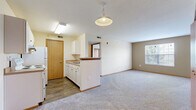Located at 55 Eastpointe Ridge Drive in Columbus, Ohio, this single-story home offers three bedrooms, one bathroom, and a practical, well-organized layout. The open-concept living and kitchen area forms the heart of the home, where wood-look flooring in the kitchen transitions seamlessly into plush carpeting in the living space. The kitchen features a peninsula with a dark wood-tone countertop, white cabinetry, a built-in sink, and a refrigerator, with pendant and overhead lighting providing ample illumination. A window in the living area allows natural light to brighten the space.

The spacious primary bedroom offers generous square footage, a large sliding-door closet, and warm neutral-toned walls. The two additional bedrooms are carpeted and each include a closet with wood-panel sliding or hinged doors, along with windows that bring in natural light and outdoor views of greenery. The full bathroom is finished with wood-look flooring, a white vanity with countertop, a mirror, and a shower with a glass sliding door. A hallway connects the rooms, and a dedicated utility room adds practical storage or laundry functionality. Overall, the home presents a clean, functional, and comfortable living environment.