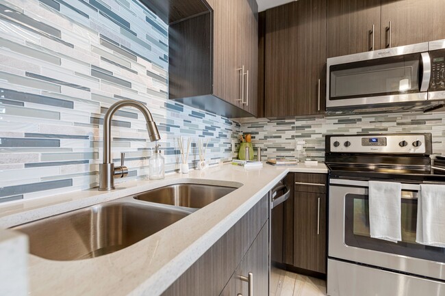 Kitchen and kitchen island within open concept apartment in Boca Raton. - Boca City Walk