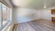 Located at 529 E Main St in Ravenna, Ohio, this one-bedroom, one-bathroom unit offers a practical and well-organized single-floor layout. The interior is finished with light gray wood-look luxury vinyl plank flooring that runs consistently throughout, creating a clean, cohesive aesthetic.

The combined kitchen and living area forms the heart of the unit. The kitchen features a full run of warm-toned wood cabinetry — both upper and lower — providing ample storage, complemented by a double-basin sink, light-colored countertops, and a white electric range. Flush-mount ceiling lighting keeps the kitchen well-illuminated.

The living area is open and bright, benefiting from natural light and a straightforward white wall finish that lends a neutral, move-in-ready feel. Baseboard heating runs along the perimeter, and a wall-mounted AC unit services the space.

The bedroom is a comfortable, private retreat with its own window overlooking the surrounding neighborhood, baseboard heating, and the same LVP flooring found throughout. A closet provides practical built-in storage.

The bathroom is clean and functional, featuring a full-sized soaking tub with an overhead shower, finished with a bright white surround. Overall, the unit offers a no-frills, functional living space suited for practical, everyday comfort.
