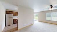 Located at 3275 40th Ave S in Saint Cloud, MN, this two-story home offers three bedrooms, three bathrooms, and an attached garage across two well-proportioned floors. The main level features an open-concept living and dining area bathed in natural light from large sliding glass doors and windows that frame views of the surrounding greenery. A ceiling fan anchors the carpeted living space, which flows seamlessly into a galley-style kitchen outfitted with rich dark wood cabinetry, granite-style countertops, stainless steel appliances including a refrigerator, range, microwave, and dishwasher, plus light hardwood-style flooring and a pendant light fixture. A full bathroom on the main level features dark wood vanity cabinetry and hardwood-style flooring. The upper floor houses three carpeted bedrooms, each with sliding-door closets providing practical storage. The generously sized primary bedroom includes its own dedicated closet space. Two additional bathrooms serve the upper level. The attached garage features an automatic opener and offers ample room for parking and storage. Neutral tones and clean finishes throughout provide a move-in-ready canvas suited for a range of tastes.