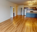 This contemporary apartment offers 1030 square feet of thoughtfully designed living space. The open-concept layout creates a seamless flow between the living areas, enhancing the sense of spaciousness. The kitchen is a highlight, featuring dark wood cabinetry, stainless steel appliances, and a large island with a light-colored countertop, perfect for meal preparation or casual dining.

The two bedrooms are generously sized, with the primary bedroom measuring 150 square feet. Both bedrooms feature plush carpeting and large windows that allow ample natural light. The two bathrooms are modern and functional, with one showcasing a combination tub/shower and wooden vanity.

A standout feature is the in-unit laundry room, equipped with full-sized washer and dryer, adding convenience to daily life. The living room is bright and airy, with hardwood flooring and large windows that offer views of the surrounding area.

Throughout the apartment, the neutral color palette and clean lines create a fresh, contemporary ambiance. The mixture of hardwood floors in the main living areas and carpet in the bedrooms adds warmth and texture to the space. With its thoughtful design and modern amenities, this apartment offers a comfortable and stylish living environment.