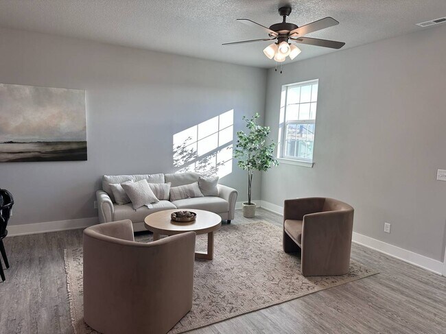Spacious living area with ample natural light - 214 NW Common Pl