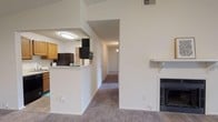 Located at 6075 Grelot Rd in Mobile, Alabama, this single-floor unit offers a well-organized layout with a comfortable, functional design throughout. The living room serves as the centerpiece of the space, featuring plush carpeting, a ceiling fan, a wood-mantled fireplace, and sliding glass doors that open to an outdoor area, flooding the room with natural light. An open entryway connects seamlessly to the kitchen, which is laid out in a galley style with warm honey-toned cabinetry, light countertops, and black appliances including a refrigerator, electric range, and over-the-range microwave. A pass-through breakfast bar separates the kitchen from the living area, enhancing the open feel. A dedicated hallway off the kitchen leads to an in-unit laundry area with wood-look flooring. The bedrooms are generously sized, each featuring soft carpeting, ceiling fans with light fixtures, and windows that bring in natural light. The bathroom is clean and efficiently designed, with wood-look flooring, a vanity with warm wood cabinetry, a large mirror, and a shower-tub combination. Throughout the unit, neutral white walls and consistent finishes create a bright, cohesive atmosphere.