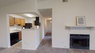 Located at 6075 Grelot Rd in Mobile, Alabama, this single-floor unit offers a well-organized layout with a comfortable, functional design throughout. The living room serves as the centerpiece of the space, featuring plush carpeting, a ceiling fan, a wood-mantled fireplace, and sliding glass doors that open to an outdoor area, flooding the room with natural light. An open entryway connects seamlessly to the kitchen, which is laid out in a galley style with warm honey-toned cabinetry, light countertops, and black appliances including a refrigerator, electric range, and over-the-range microwave. A pass-through breakfast bar separates the kitchen from the living area, enhancing the open feel. A dedicated hallway off the kitchen leads to an in-unit laundry area with wood-look flooring. The bedrooms are generously sized, each featuring soft carpeting, ceiling fans with light fixtures, and windows that bring in natural light. The bathroom is clean and efficiently designed, with wood-look flooring, a vanity with warm wood cabinetry, a large mirror, and a shower-tub combination. Throughout the unit, neutral white walls and consistent finishes create a bright, cohesive atmosphere.