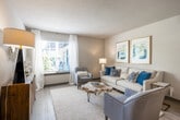 This thoughtfully designed 2-bedroom, 3-bathroom residence in Vestavia Hills, Alabama offers a comfortable and functional single-floor layout. The living room serves as the heart of the home, featuring light hardwood-style flooring, a textured ceiling, and a large window that fills the space with natural light and views of the surrounding greenery. Neutral wall tones create a calm, welcoming ambiance throughout.

The kitchen is well-equipped with gray shaker-style cabinetry, granite countertops, stainless steel appliances, and hardwood-style flooring — flowing seamlessly into a dedicated dining area. The primary bedroom is generously sized, complete with plush carpet, a ceiling fan, a large window, and ample closet space. The second bedroom also features carpet flooring and its own closet. Three full bathrooms provide convenience, with at least one showcasing granite countertops, dark cabinetry, a large vanity mirror, and clean tile work in the tub/shower surround. Additional closets offer abundant storage, including a walk-in closet with wire shelving. A utility room rounds out the layout, adding practical functionality to this well-organized residence.