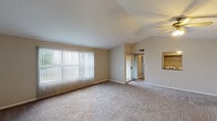 Located at 1770 Tanglewood Ct in Burlington, Kentucky, this single-story home offers a thoughtfully designed layout with comfortable living spaces throughout. The main living area is a standout feature, boasting vaulted ceilings that lend an open, airy quality to the room. Large vertical blinds covering a sliding glass door allow abundant natural light to fill the space, while a ceiling fan adds both style and function. Neutral-toned carpet flows throughout the living areas and bedrooms, creating a cohesive and inviting atmosphere.

The kitchen is well-appointed with rich wood cabinetry offering generous storage, stone-patterned countertops, and a stainless steel range with an overhead ventilation hood, providing a practical and attractive cooking environment.

The bedrooms are generously sized, each featuring plush carpeting and windows that bring in natural light. The primary bedroom includes direct access to a private bathroom and a dedicated walk-in closet, while an additional bedroom offers a standard closet and an outdoor view through a well-placed window.

The bathroom features light tile flooring, a wood-toned vanity with a white countertop, and a clean, functional layout with an adjoining walk-in closet area. Overall, the home presents a well-maintained, neutral palette that offers a comfortable and versatile living environment.