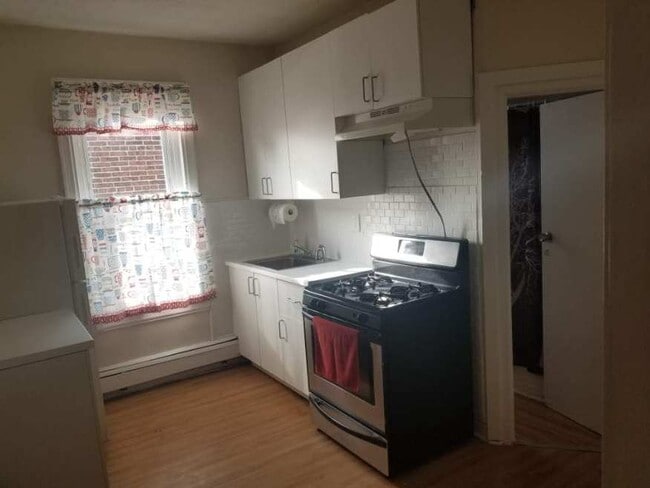 Kitchen, door on the right goes into bathroom. - 3534 N 8th St