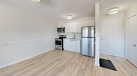 Located at 1050 Highland St in Burlington, Ontario, Unit 4 is a thoughtfully laid-out one-bedroom, one-bathroom unit situated on a single floor. Light-toned hardwood-style flooring runs throughout, lending a clean and cohesive look to the space.

The combined dining and living area is generously proportioned, featuring multiple windows that bring in natural light and offer views of the surrounding outdoor greenery. A textured ceiling adds subtle character to this main living space, which also includes baseboard heating.

The kitchen is efficiently designed with crisp white cabinetry, a stainless steel undermount sink, light-toned countertops, and a full suite of stainless steel appliances including a refrigerator, electric range, and microwave. The layout makes smart use of the available space.

The bedroom is a comfortable, quiet retreat with its own window overlooking the outdoors and baseboard heating. It features two closets with classic panel doors, offering practical storage solutions. The bathroom is clean and functional, appointed with a full-sized tiled tub-shower surround and modern fixtures.

The unit also includes a dedicated entrance and additional unclassified space, rounding out a practical and move-in-ready layout ideal for individuals or couples seeking a manageable, low-maintenance home in Burlington.