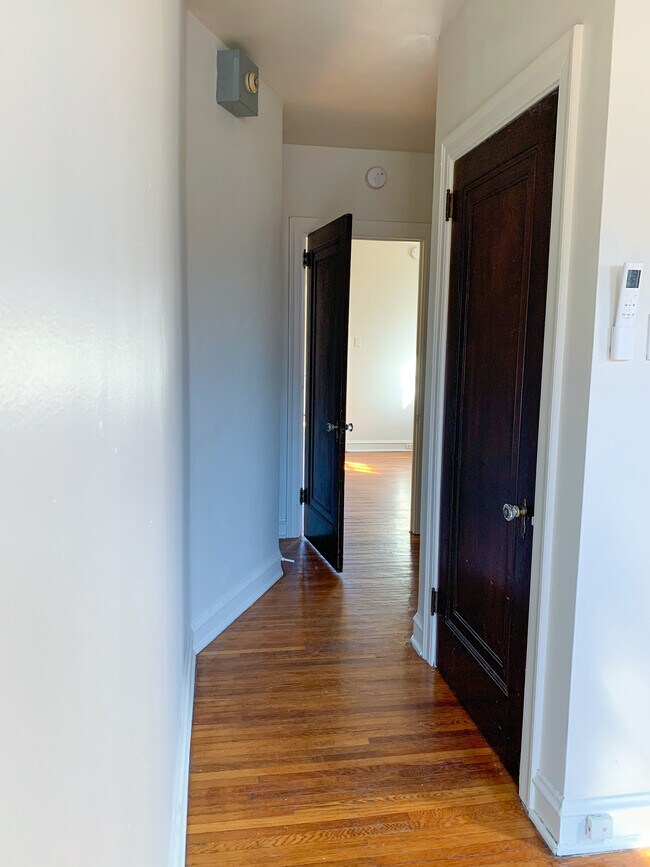 View looking out of bedroom into living space (closet #2 and bathroom on right). - 325 N Duke St