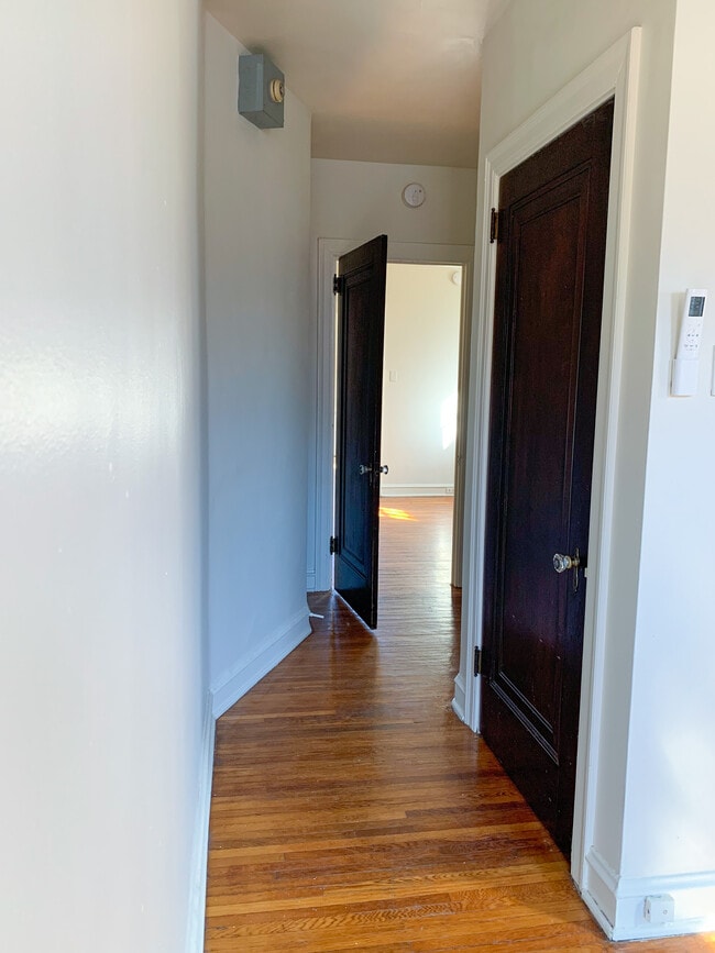 View looking out of bedroom into living space (closet #2 and bathroom on right). - 325 N Duke St