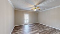 Located at 620 Dillon Trace St in Sumter, South Carolina, this well-appointed two-bedroom, two-bathroom single-story home offers a comfortable and functional layout. Throughout the home, durable wood-look plank flooring provides a cohesive and attractive foundation, complemented by neutral beige walls that create a warm, inviting atmosphere.

The living room is generously sized, featuring crown molding, a textured ceiling, a ceiling fan with light fixture, and a door that lets in natural light. The kitchen is well-equipped with warm-toned wood cabinetry, white appliances including a refrigerator, range, microwave, and dishwasher, along with a breakfast bar and crown molding accents.

The spacious primary bedroom offers ample room, a ceiling fan, a window for natural light, and direct access to a dedicated closet. The second bedroom also features a ceiling fan and a bright window. Both bathrooms are practical and clean, with one including a full tub-shower combo, a wood-toned vanity, and a mirror. A dedicated laundry room with overhead cabinetry adds convenient storage. This home combines everyday functionality with consistent, tasteful finishes throughout.