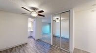 Located at 996 Meridian Ave in San Jose, California, this two-bedroom, two-bathroom residence offers a well-organized single-level layout designed for comfortable everyday living. The combined kitchen and living area serves as the heart of the home, with the kitchen featuring white shaker cabinetry, quartz countertops, a stainless steel sink, wood-look flooring, and a pass-through window that connects to the living space and brings in natural light. The living room is carpeted and includes baseboard heating and a ceiling fan, flowing naturally toward the rest of the unit. The spacious primary bedroom is generously sized with soft carpet, a baseboard heater, and a large window that invites natural light and outdoor views. The second bedroom is similarly carpeted with neutral tones and clean lines. Both bathrooms are updated with wood-look flooring and white finishes — one features a tub/shower combination with white tile and grab bars, while the other offers a standalone glass-enclosed shower with a vanity. A dedicated closet provides additional storage. A private balcony off the unit overlooks mature trees, offering a serene outdoor retreat in the heart of San Jose's Meridian neighborhood.