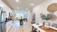 Located at 4710 Old Decatur Rd in Fort Worth, TX, this well-appointed one-bedroom, one-bathroom unit offers a thoughtfully designed single-floor layout with modern finishes and an efficient use of space. The open-concept main area seamlessly integrates the living room, dining area, and kitchen, all united by warm light wood-tone flooring and crisp white walls that enhance the sense of brightness throughout. Large windows in the living area invite generous natural light and provide outdoor views, while a ceiling fan adds a practical touch overhead. The kitchen is a standout feature, boasting white shaker cabinetry, dark granite countertops, a white subway tile backsplash, and a full suite of stainless steel appliances including a refrigerator, dishwasher, range, and built-in microwave. The bedroom is a comfortable retreat with large windows that frame outdoor views, light wood flooring, recessed lighting, and a ceiling fan. A hallway leads to the well-designed bathroom, which features a wide vanity with dark stone countertops, white cabinetry, and a large mirror with ample lighting. The unit also includes a dedicated laundry area and utility room, offering added convenience. Clean lines, recessed lighting, and a neutral palette give the entire space a cohesive, contemporary feel.