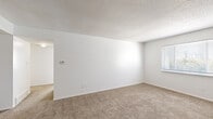 Located at 9316 Old Santa Fe Rd in Kansas City, MO, this single-floor, 2-bedroom, 2-bathroom home offers a functional and straightforward layout. The spacious living area features neutral-toned carpet, crisp white walls, and a textured ceiling, creating a clean and versatile canvas. Natural light filters in through blinds-equipped windows, lending brightness to the open space.

The generously sized primary bedroom offers ample room for furnishings, with soft carpeting underfoot, white walls, and a window providing natural light. The second bedroom mirrors this design with its own window and similarly comfortable carpeting. Both rooms are well-proportioned and move-in ready.

The kitchen is efficiently designed in a U-shaped layout, featuring abundant white cabinetry, brown laminate countertops, tile flooring, and white appliances including a range and dishwasher — providing solid functionality and storage.

Both bathrooms are finished with tile flooring, white vanity cabinetry, and brown laminate countertops. One bathroom includes a window for natural ventilation and a bathtub/shower combination.

A connecting hallway ties the layout together, providing easy access to all rooms. The overall design is clean, practical, and well-maintained, making this home a comfortable and efficient living space.