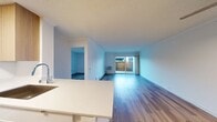This 580 square foot apartment in Newport Beach offers a thoughtful blend of modern design and practical living. The space comprises one bedroom, one bathroom, and an open-concept kitchen and living area, all on a single floor. The primary bedroom, measuring 180 square feet, provides ample space for rest and relaxation.

The kitchen is a highlight, featuring sleek white cabinetry complemented by warm wood tones. Stainless steel appliances, including a full-size refrigerator and range, cater to culinary needs. The countertops appear to be quartz or a similar high-quality material, offering both durability and style.

Throughout the apartment, beautiful hardwood flooring adds warmth and elegance. The bathroom, while compact, includes a full-size bathtub and shower combination. Large windows in the living area and bedroom allow natural light to flood the space, creating an airy atmosphere. A sliding glass door in the living room leads to an outdoor area, extending the living space and providing a connection to the coastal environment.

The overall design aesthetic is clean and minimalist, with neutral color palettes that allow for personal customization. Built-in storage solutions and efficient use of space make this apartment ideal for those seeking a low-maintenance yet stylish coastal living experience in the heart of Newport Beach.
