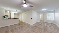 Located at 316 Columbia Dr in Carrollton, GA, this apartment offers a well-organized single-floor layout with three bedrooms, three bathrooms, a combined kitchen and living area, and a dedicated utility room. The kitchen is outfitted with light wood cabinetry, dark countertops, stainless steel appliances including a refrigerator, electric range, over-the-range microwave, and dishwasher, all set atop wood-look flooring. Open shelving provides additional pantry storage. The living area flows naturally from the kitchen and features the same durable hard-surface flooring. Each of the three carpeted bedrooms is finished with neutral beige tones, white trim, and window blinds that allow natural light while maintaining privacy. The primary bedroom includes a ceiling fan with light fixture. The bathrooms are clean and functional, each featuring a soaking tub with shower combination, white surrounds, and chrome fixtures. One bathroom features a white vanity with ample drawer storage. Throughout the unit, a consistent neutral color palette and clean finishes create a bright, cohesive atmosphere. The utility room adds practical convenience to this thoughtfully designed residential space.