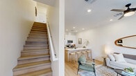 Located in Phoenix, AZ, this two-story home offers four bedrooms and three bathrooms thoughtfully laid out across two floors. The main level features an open-concept kitchen and living area bathed in recessed lighting and finished with warm light wood flooring. The modern kitchen is equipped with stainless steel appliances, two-tone cabinetry combining white uppers with natural wood lowers, and a sleek white quartz waterfall island with bar seating — ideal for casual dining and entertaining. The living room is bright and inviting, with access to a private balcony and clean white walls that complement the contemporary aesthetic. Three well-appointed bathrooms feature matte black hardware accents and light wood flooring for a cohesive, modern look. Upstairs, the bedrooms are generously proportioned, including a primary suite with large windows that frame open outdoor views and a ceiling fan for added comfort. Additional bedrooms offer flexible use, with ample natural light and scenic Arizona views. A hallway connects the upper-floor rooms, maintaining a clean and efficient flow. Throughout the home, the design is characterized by a neutral palette, natural materials, and minimalist styling that together create a calm, contemporary living environment.