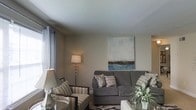 Located at 248 Presidential Drive in the sought-after 19807 zip code of Wilmington, Delaware, this single-floor residence offers a thoughtfully designed layout with a welcoming atmosphere throughout. The living area serves as the heart of the home, showcasing neutral-toned walls that create a calm, versatile backdrop for a variety of décor styles. Smooth ceilings lend a clean, polished look to the space, while natural light filters in through curtained windows, brightening the room with an airy quality. The living room is generously proportioned, comfortably accommodating a full sofa and accent seating, making it well-suited for both relaxed everyday living and entertaining guests. Subtle decorative touches, including patterned throw pillows and coordinated furnishings in warm grays and taupes, contribute to a cohesive and inviting ambiance. A tasteful piece of wall art depicting a serene landscape adds a focal point to the room, reinforcing the tranquil tone of the interior. The overall design of the home reflects a straightforward, functional single-floor plan that prioritizes comfort and ease of movement, making it an ideal setting for those seeking a practical yet stylish living environment in Wilmington.