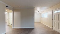 Located at 13751 Edwards St in Westminster, California, this single-story home offers a well-designed layout with consistent finishes throughout. The living areas feature durable wood-look vinyl flooring in a rich dark tone, crisp white crown molding, and neutral warm beige walls that create a clean, inviting atmosphere. Natural light filters in through window blinds across multiple rooms, enhancing the open feel of the space.

The kitchen is thoughtfully appointed with light wood cabinetry, dark granite-style countertops, and black appliances including a gas range and built-in microwave. A double sink sits beneath a window, and recessed lighting illuminates the workspace efficiently.

The bedrooms continue the wood-look flooring and are each equipped with ceiling fans and ample natural light. One bedroom features mirrored sliding closet doors, adding a sense of depth and additional reflective light. An additional room with built-in wood cabinetry provides versatile storage or display space.

The bathroom includes a tub and shower combination enclosed by sliding glass doors, a pedestal sink, and wood-look flooring that ties cohesively to the rest of the home.

Crown molding and ceiling fans are present in the main living areas, further contributing to the home's polished, comfortable character throughout.